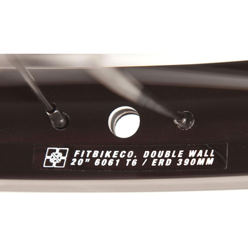 A close up of a Fit Bike Co OEM 20 Inch Wheel Set with a label on it.