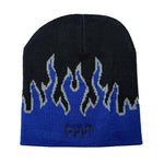 The Cult Flame Beanie is a black and blue acrylic skull cap featuring a gray and blue flame pattern and an embroidered "CULT" logo on the front.