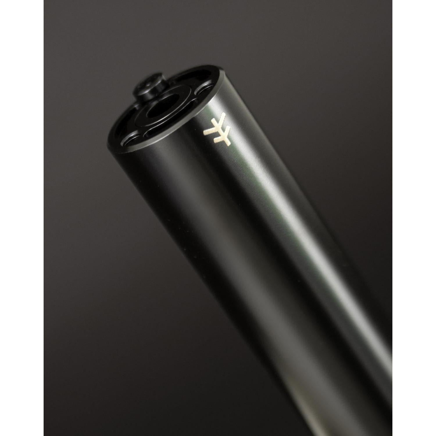 Close-up of the sleek black Fly Bikes Acero ST Peg, expertly CNC machined from 4140 Cr-Mo, featuring a subtle logo on its surface, against a dark background.