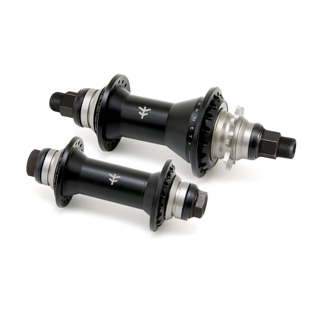 Diagonally positioned, the Fly Bikes Magneto Hub Set (Crmo) features two black hubs with silver accents and threaded axles, equipped with oversized bearings for enhanced performance.