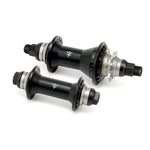 Diagonally positioned, the Fly Bikes Magneto Hub Set (Crmo) features two black hubs with silver accents and threaded axles, equipped with oversized bearings for enhanced performance.