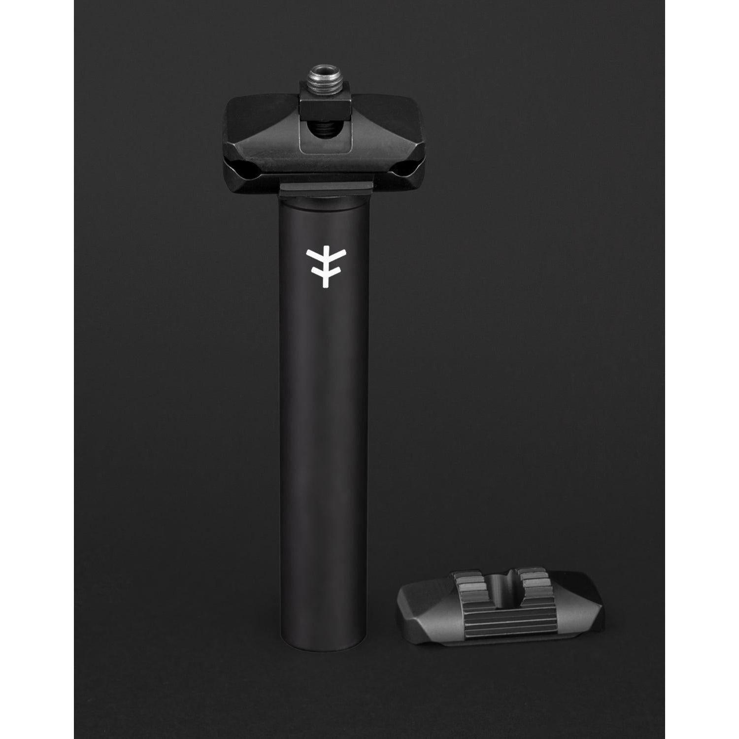The Fly Bikes Motosierra Railed Seat Post is a sleek black cylindrical post made of CNC machined 6061-T6 aluminum, featuring a logo and an accompanying bracket. Ideal for those who value durability and precision in a ripper seat post.