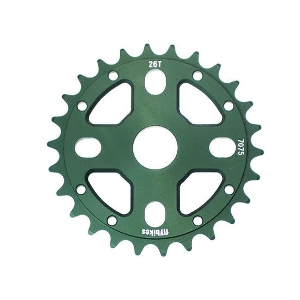 The Fly Bikes OG Sprocket (NOS) is a CNC-machined green bicycle sprocket made from 7075 aluminum, featuring 26 teeth, numerical markings, and multiple attachment holes.