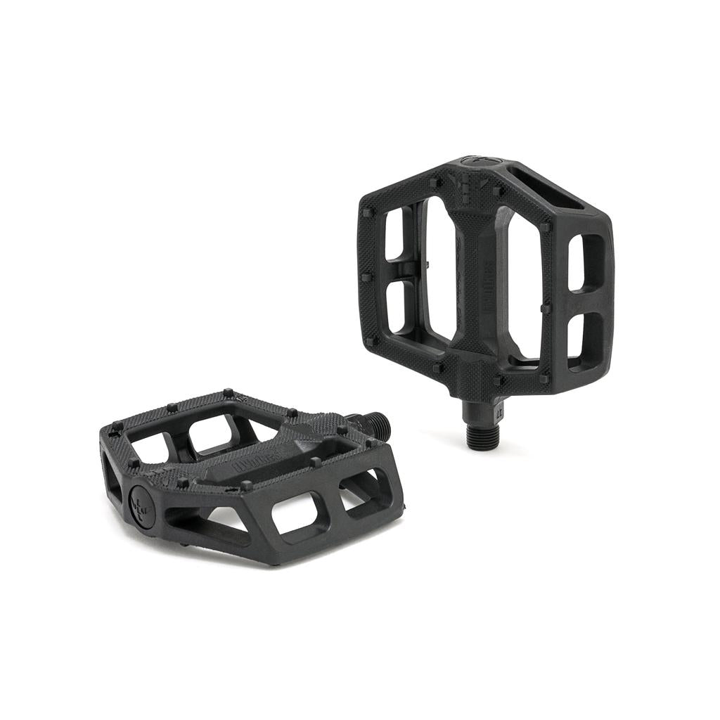 The Fly Bikes Ruben Pedals (Graphite) are sturdy black bicycle pedals with a hexagonal shape and open framework, crafted from a durable nylon fiberglass compound and featuring a robust chromoly axle, shown against a white background.