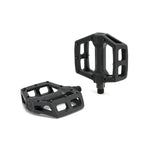 The Fly Bikes Ruben Pedals (Graphite) are sturdy black bicycle pedals with a hexagonal shape and open framework, crafted from a durable nylon fiberglass compound and featuring a robust chromoly axle, shown against a white background.