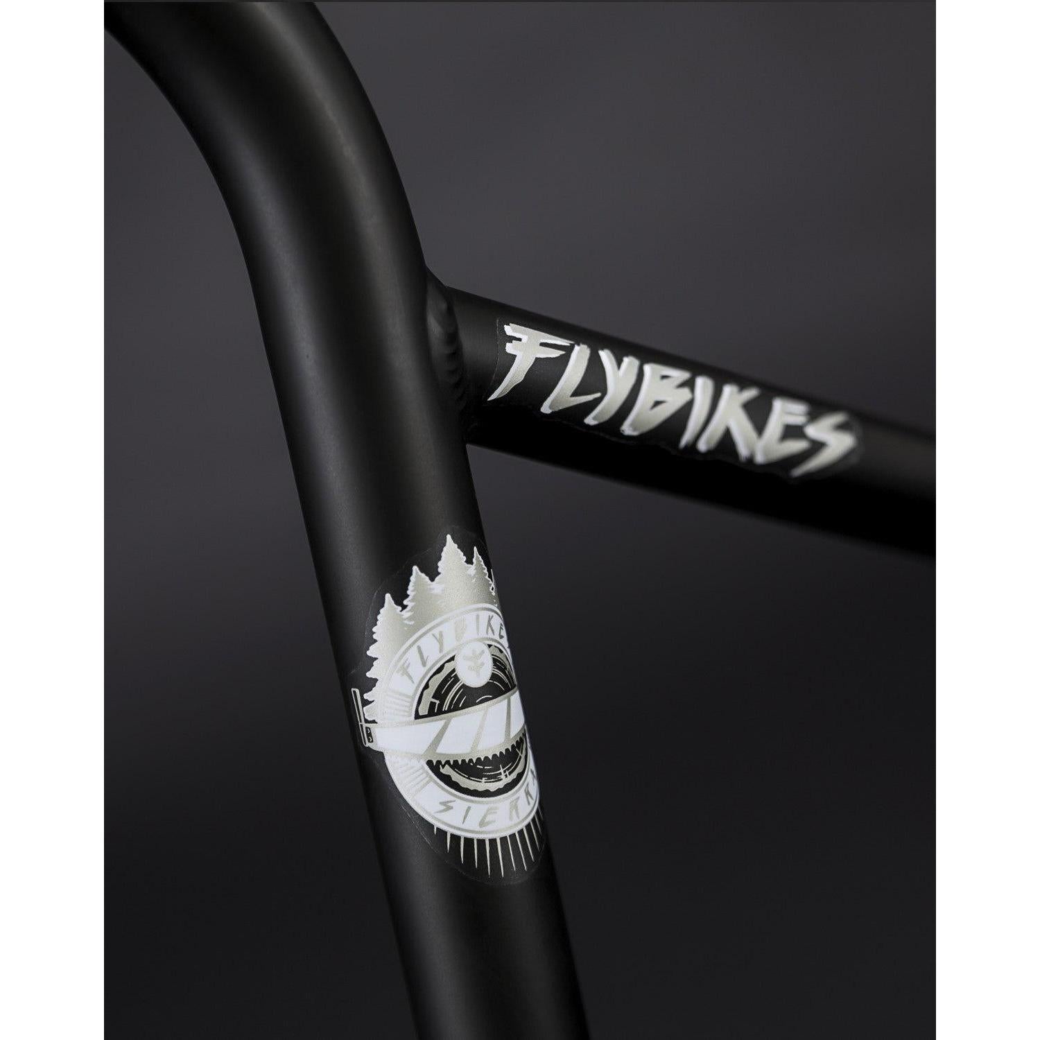 Close-up of the Fly Bikes Sierra Bars in black, crafted with 4130 CrMo. The design features the "FLYBIKES" logo and tree-mountain motifs, embodying Sergio Layos' signature style.