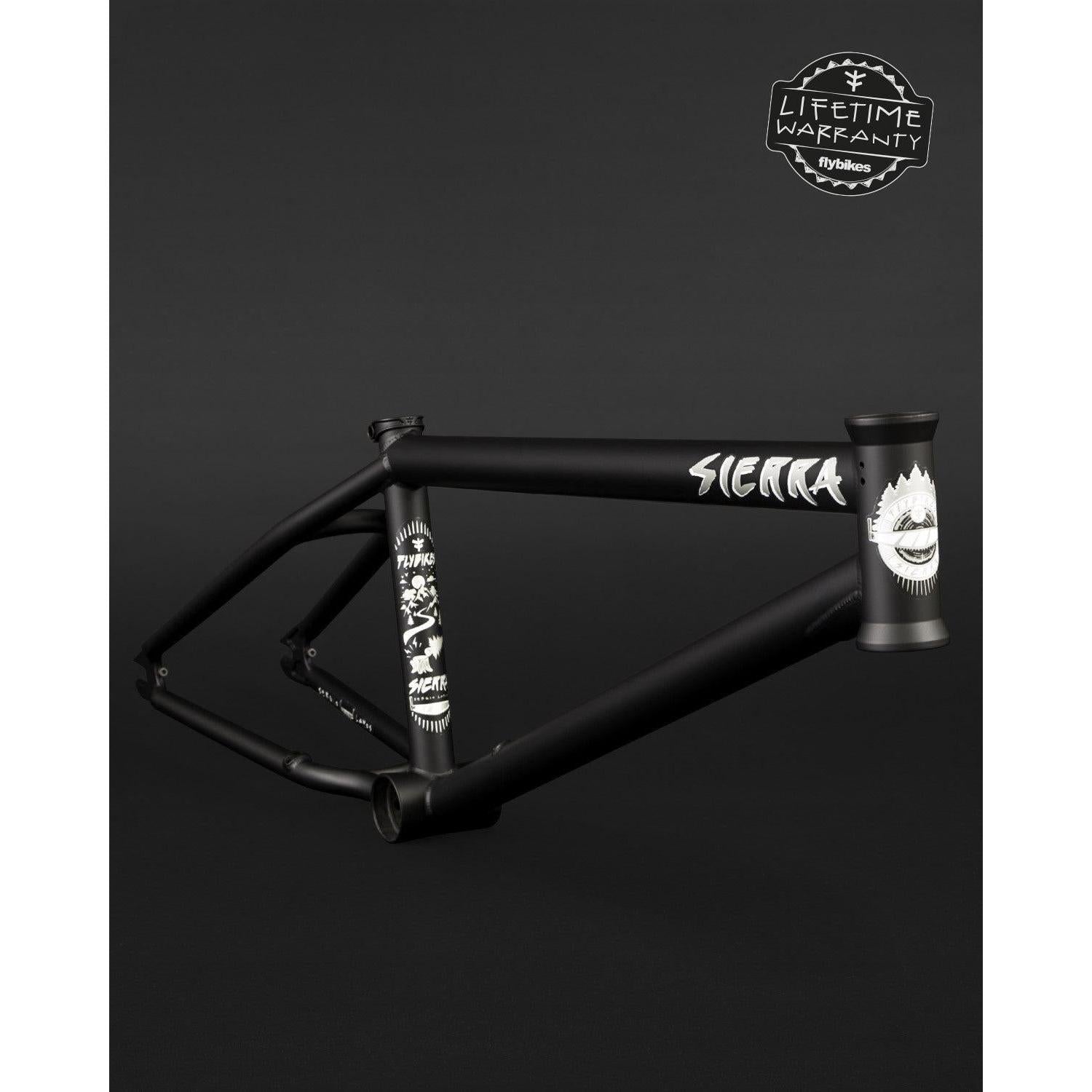 The Fly Bikes Sierra Frame offers durability with its black 4130 CrMo construction, highlighted by sleek white graphics and "SIERRA" text. A "Lifetime Warranty" badge in the top right corner guarantees a trustworthy investment for riders.