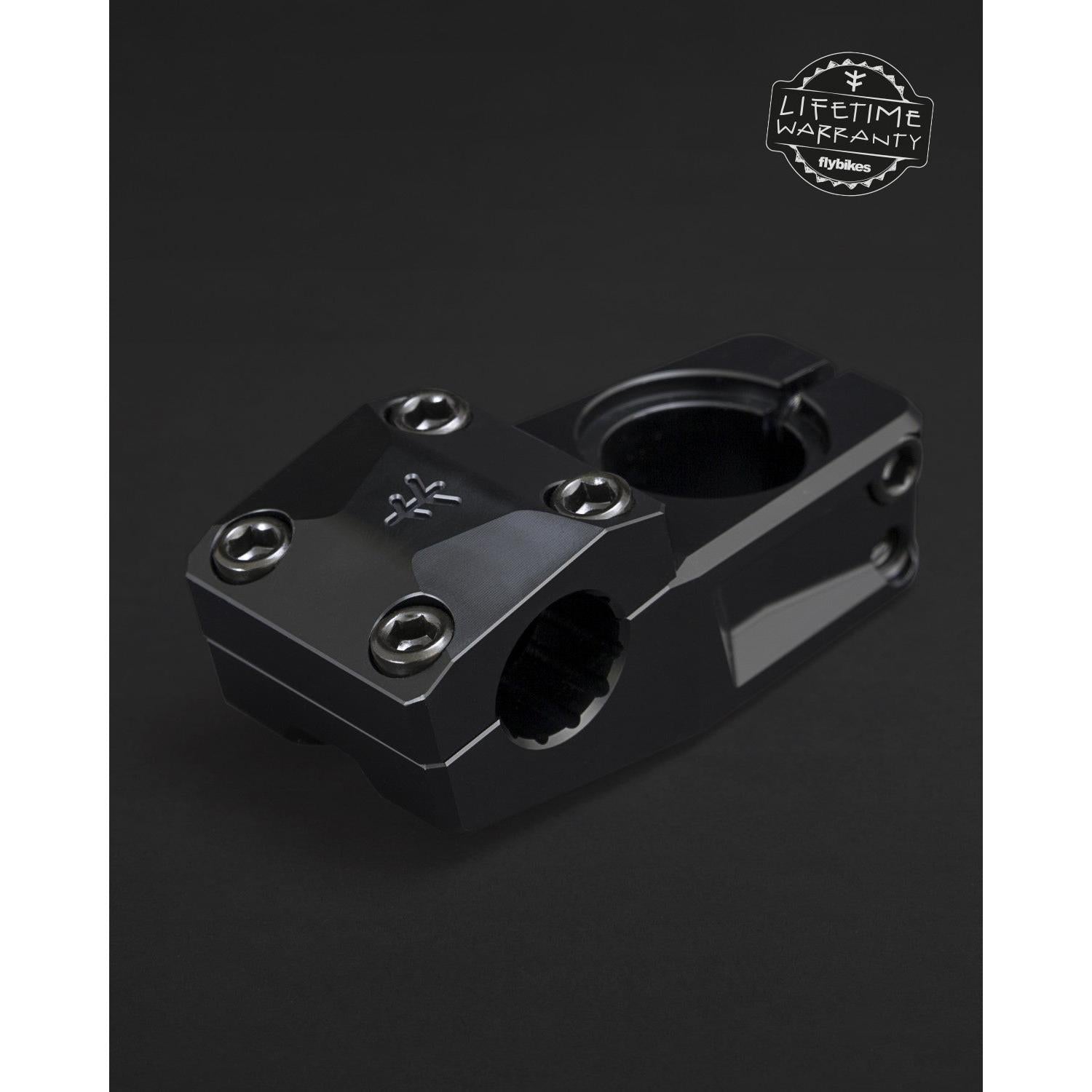 The Fly Bikes Volcano 25 Stem (S) is made from durable 6061-T6 Aluminum with a sleek black hexagonal design, secured by four bolts and featuring a logo on top. Precision CNC machined for strength, it proudly displays a "Lifetime Warranty" badge in the top-right corner.