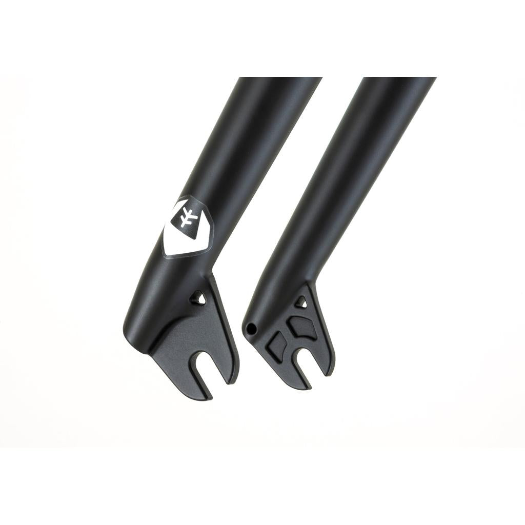 Close-up of black Fly Bikes Volcano Forks dropouts with BMX steer-tubes, showcasing mounting points and a logo on one side, against a plain white background.