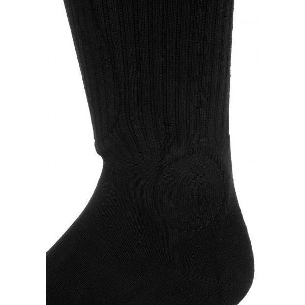 Close-up image of a black FP Painkiller Socks Black Knee Hi with a reinforced circular patch stitched on the heel area.