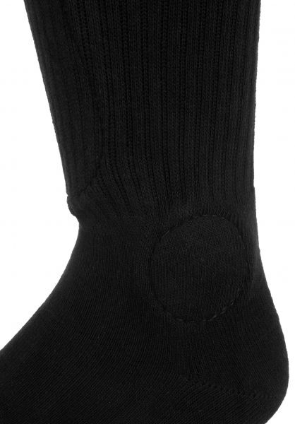 Close-up image of a black FP Painkiller Socks Black Knee Hi with a reinforced circular patch stitched on the heel area.