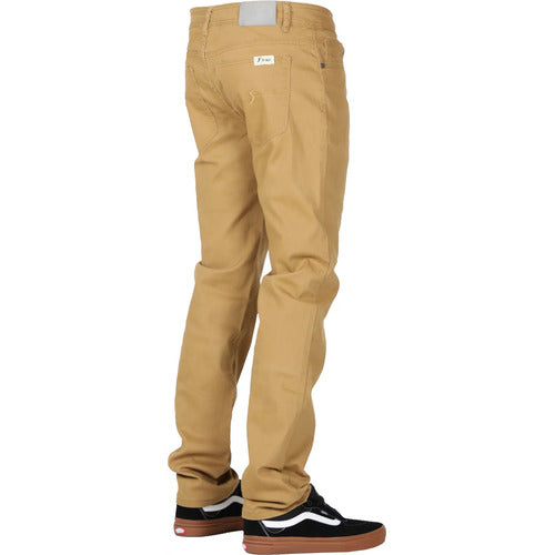Person wearing FP Pants Relaxed Fit Chino Tan and black and white sneakers, standing with the back facing the camera.