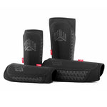 Four GAIN STEALTH Shin Guards in black, crafted with DuraTec neoprene for enhanced durability, displayed on a white background.