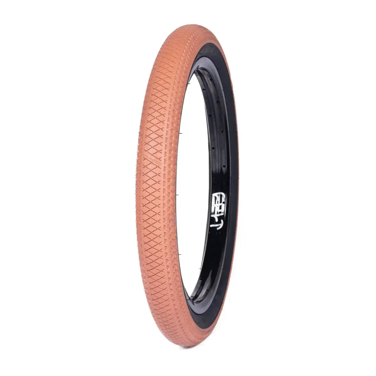 The Cult X Vans Wafflecup 20 Inch Tyre, featuring a brown color, black inner rim, and textured tread pattern, is displayed upright against a white background.
