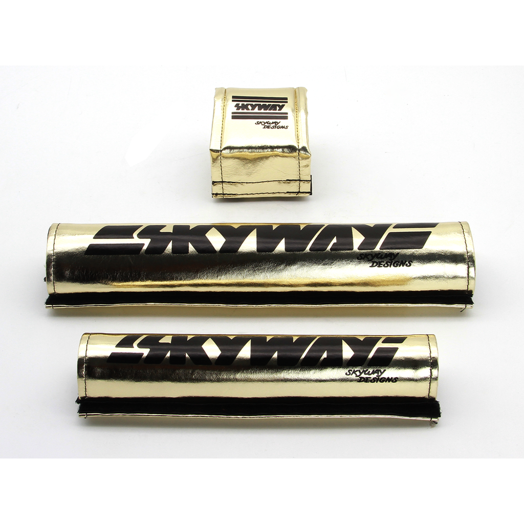A set of gold and black SKYWAY USA Made Retro Pad Set tin cans, reminiscent of the 80's era.