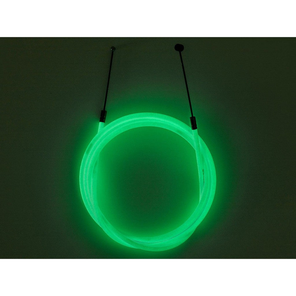 A Odyssey Linear Slic SLS Cable coated green glowing wire hanging on a wall.