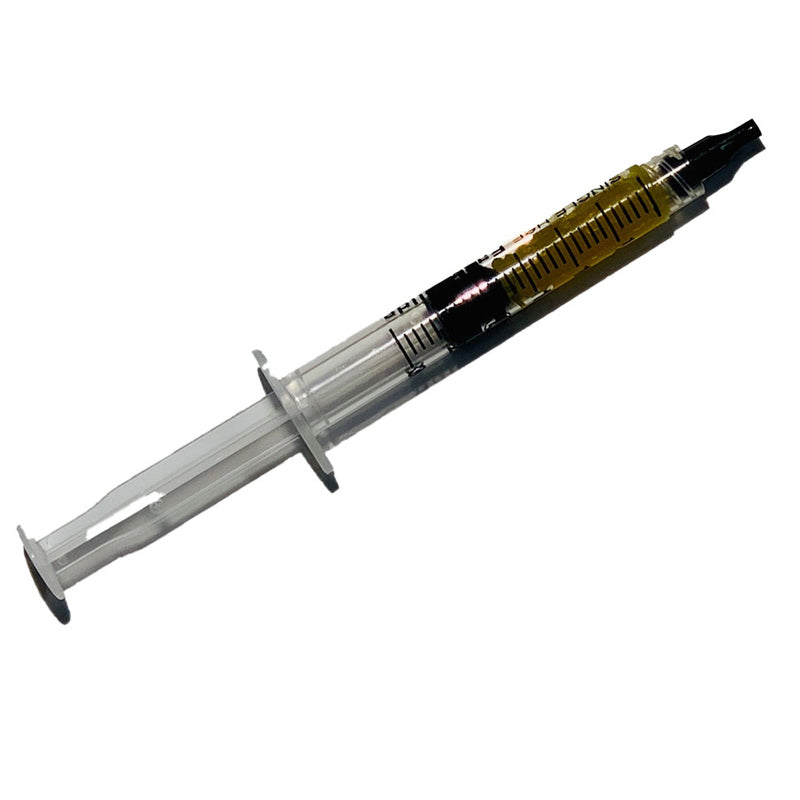 A transparent syringe filled with a dark liquid, featuring a clear barrel and plunger, is shown against a plain white background, reminiscent of the precision found in the Kluber Lubricant (Syringe 2 Grams) LDS 18 Special A.