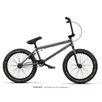 Side view of the Wethepeople Arcade 20 Inch Bike, a black mid-tier BMX with camouflage tires, Salt Valon rims, black handlebars, and seat, displayed on a white background.