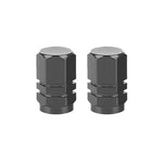 Two black Hexagon Valve Caps (Pair) with a grooved design rest on a white background, ready to add the perfect finishing touch to your ride.