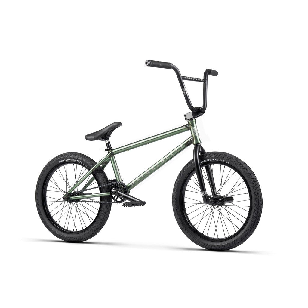 The Wethepeople Revolver 20 Inch Bike, a green BMX with premium components and black handlebars, tires, and seat, is displayed in side profile against a white background.