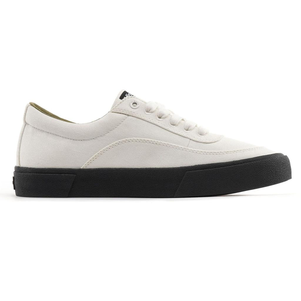 The Higher Crypt Canvas Lace Up Shoes (Raw Ecru/Black) feature a white canvas upper with reinforced panels and a black grippy sole, shown in a side view on a white background—ideal BMX shoes combining style and durability.