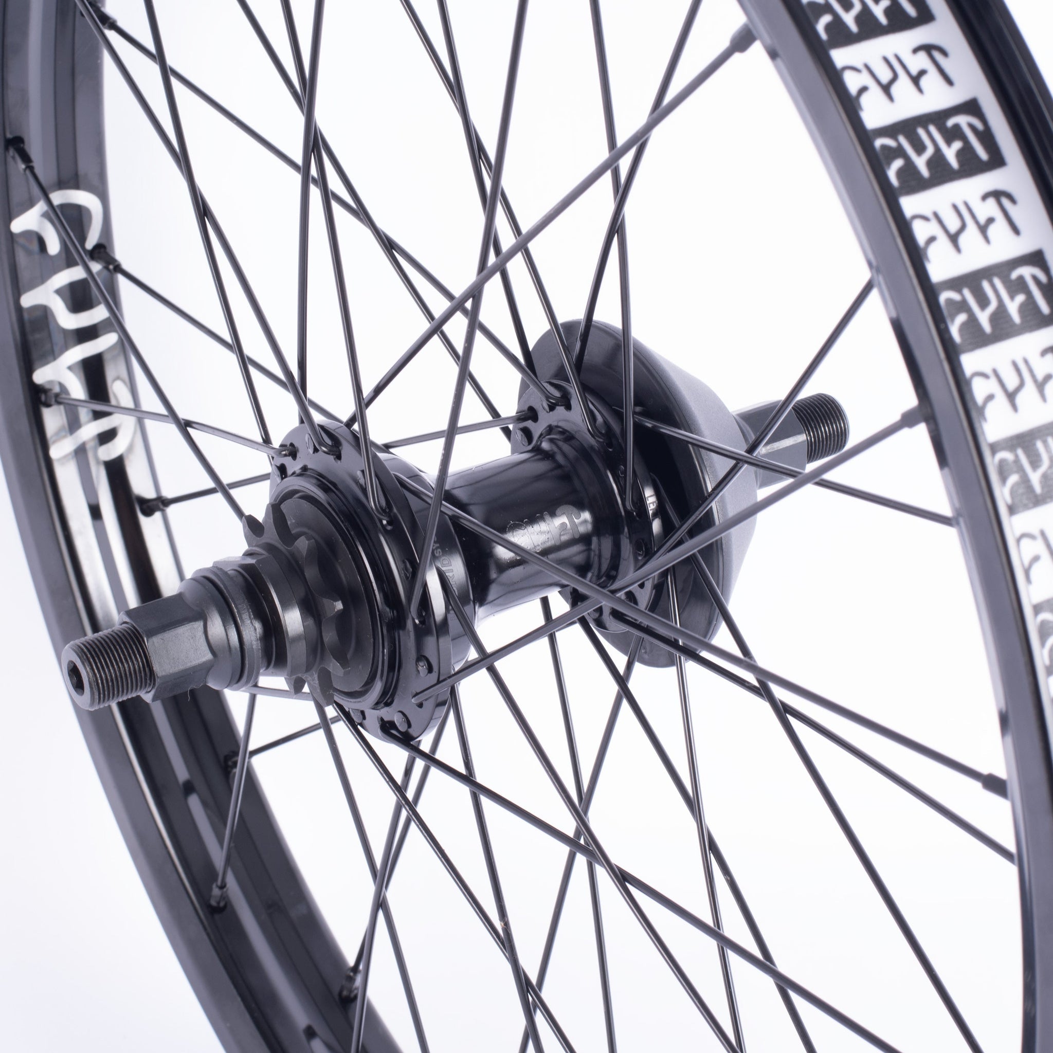 Close-up of the Cult Hybrid FC Wheel, showcasing black spokes, a freecoaster hub, and a Cult Match V2 rim with white graphics against a light background.