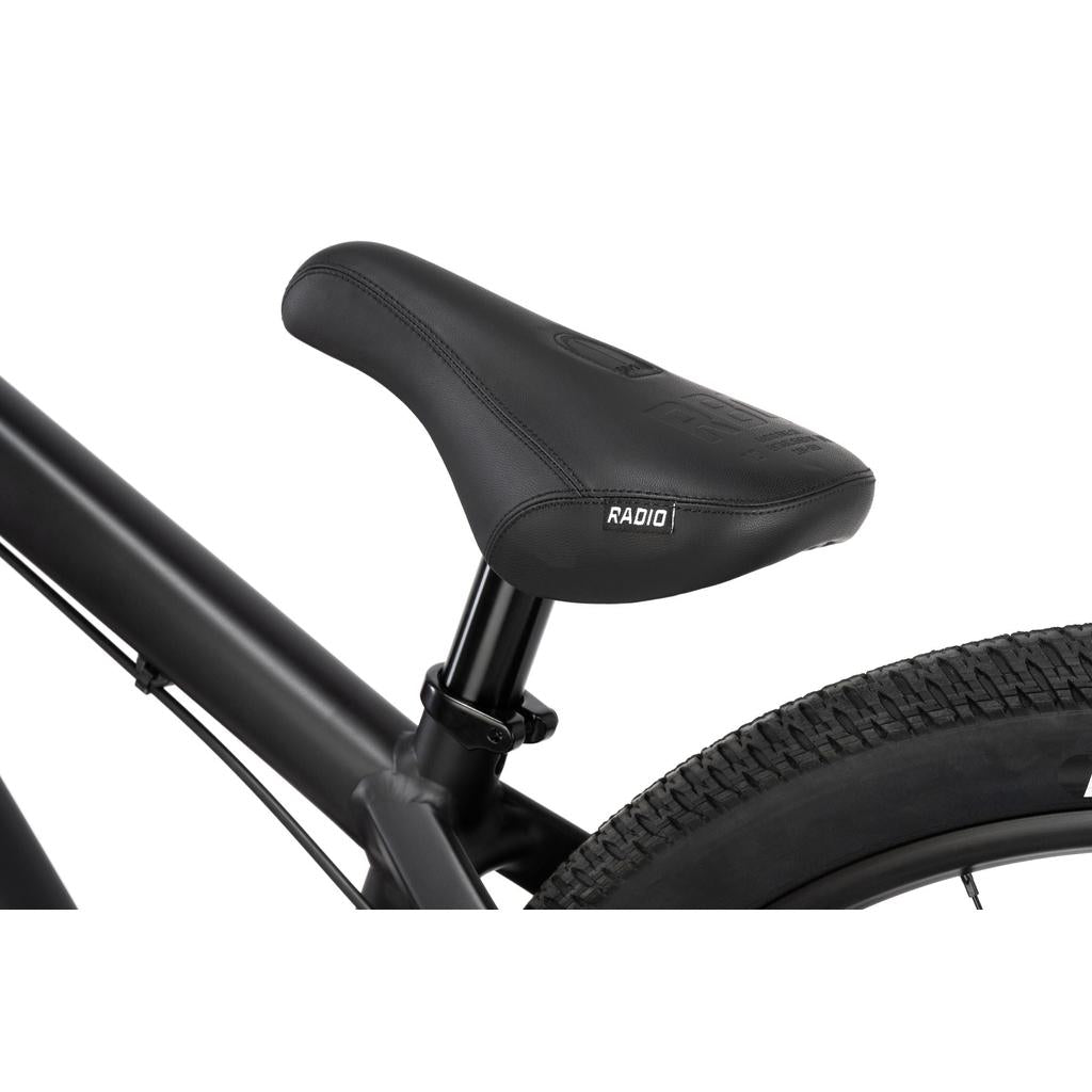 Close-up of a black saddle and seat post on the Radio 26 Inch Griffin Pro Bike, showing part of its alloy frame and rear tire.