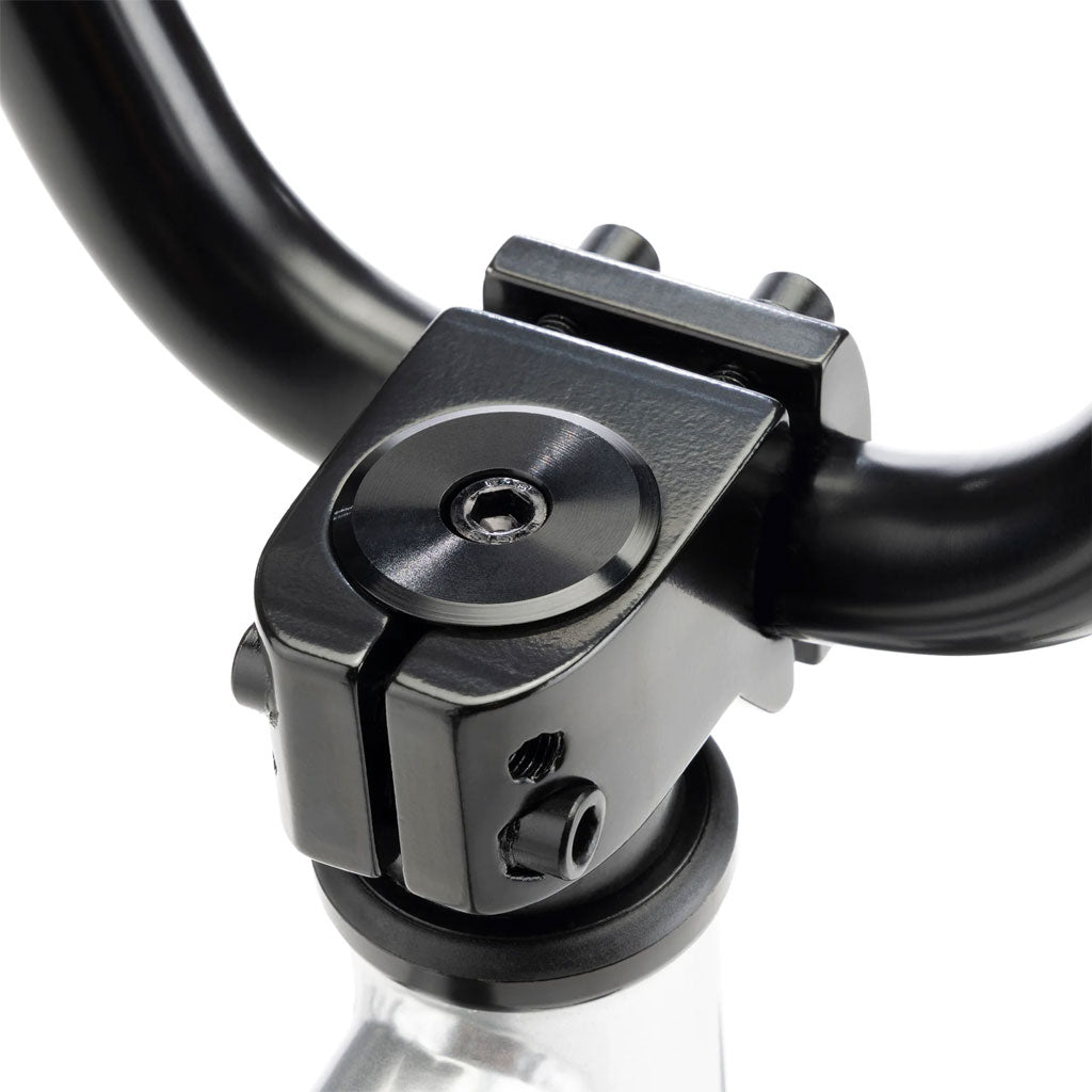 Close-up of a black handlebar stem secured with screws on a silver fork tube, similar to the sleek design found in the Kink Coast 12 Inch Balance Bike.