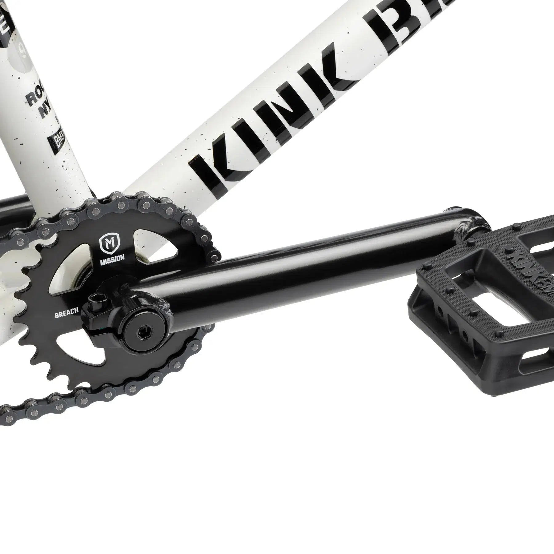 Detailed view of the crankset and pedal assembly on a Kink Gap 20 Inch Bike, highlighting the black chainring and pedal against its semi-chromoly frame.