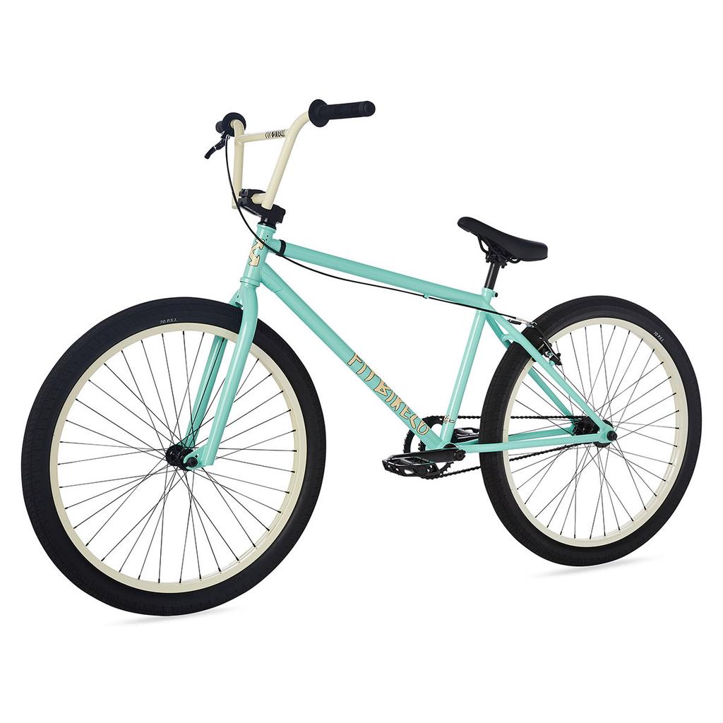 The Fit CR26 Inch Bike features a light blue cr-mo frame, cream-colored tires, and black seat, pedals, and handlebars, displayed on a white background.