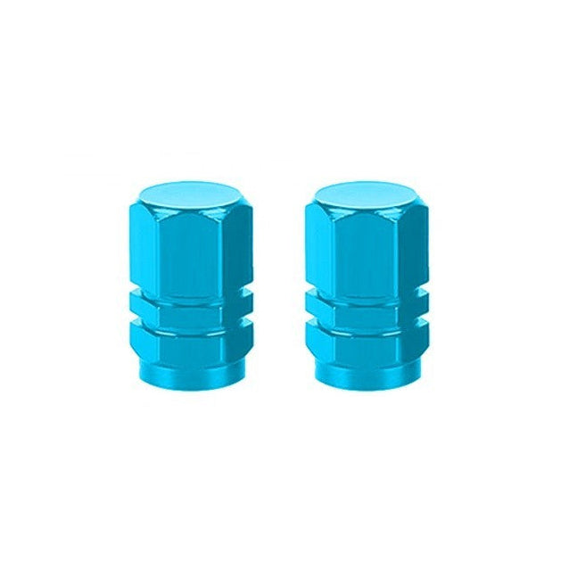 The Hexagon Valve Caps (Pair) in blue bring vibrant color to a white backdrop with their distinctive metal hexagonal design.