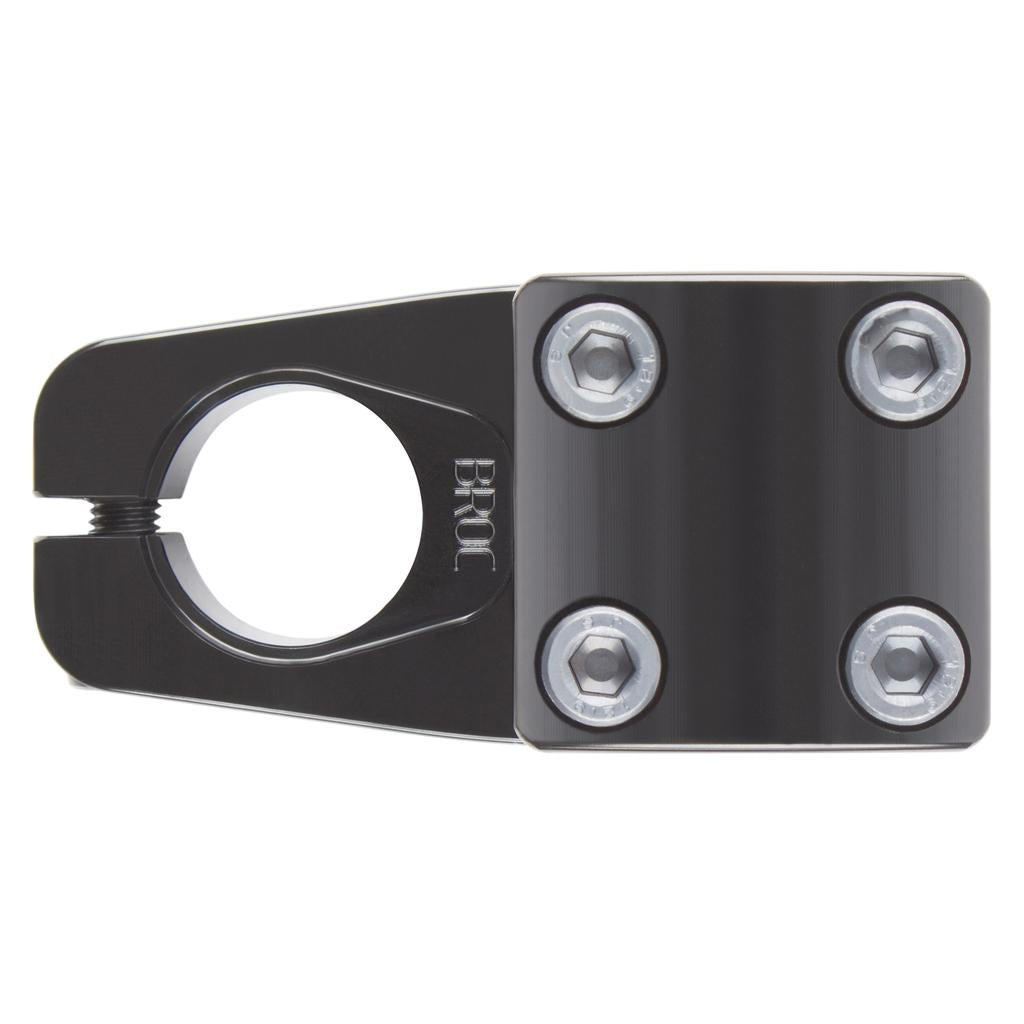 The Odyssey Broc Raiford V2 Stem is a black metal BMX stem with four hex bolts and a "BROC" clamp, designed to securely hold BMX handlebars for a strong, reliable grip.