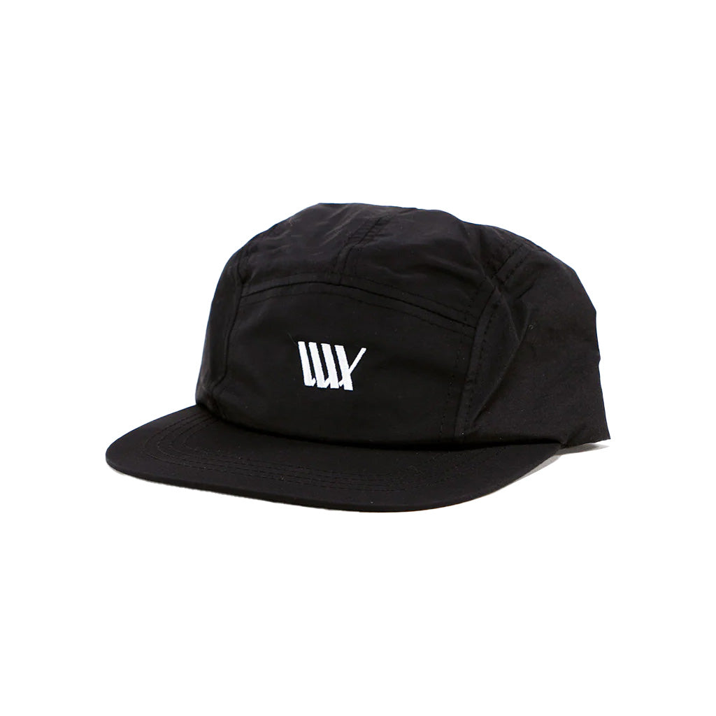 An LUXBMX Aero 5 Panel Cap - Black with an embroidered LUXBMX logo in white on a black hat.
