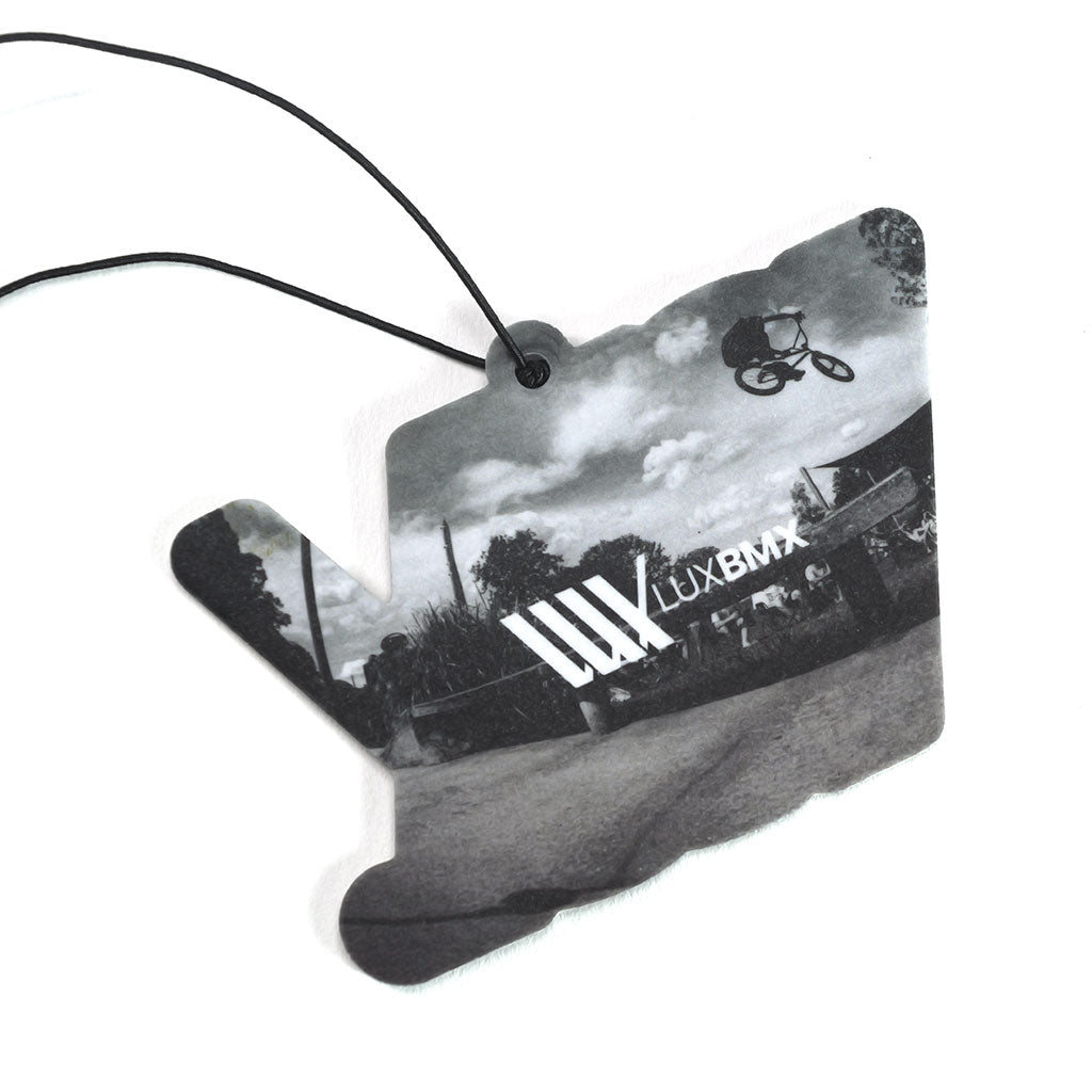 The LUXBMX Air Freshener - Josh Dove is a black-and-white hand-shaped freshener with a forest scent, featuring BMX rider Josh Dove mid-jump, "LUXBMX" text, and hangs by a black string.