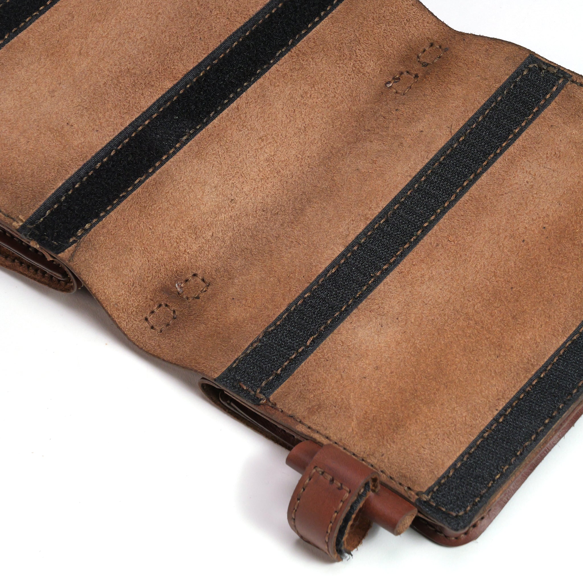 A close-up of the LUXBMX Deluxe Leather Frame Bag, made from full-grain leather with black fabric bands and visible stitching, shown open and laid flat on a white surface.