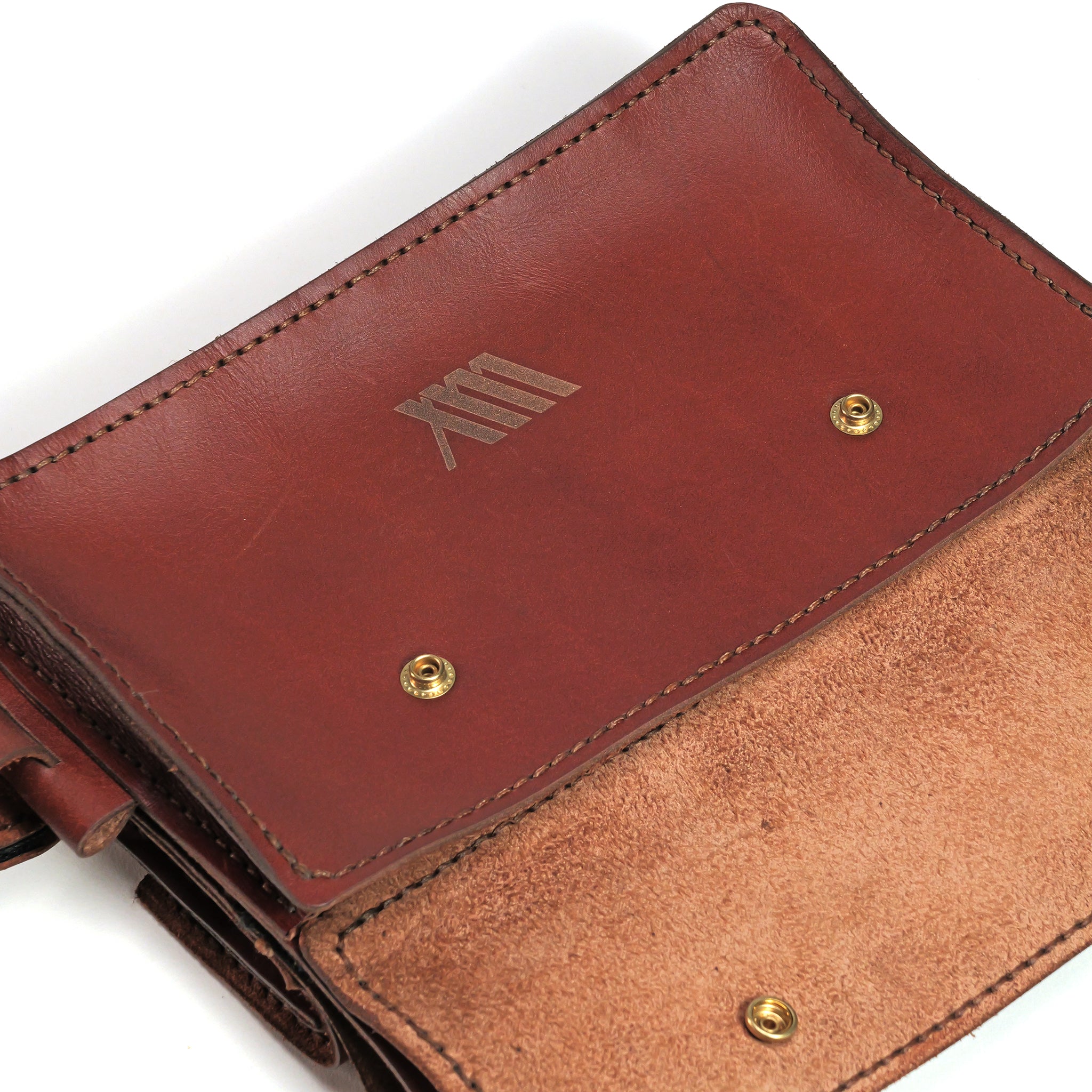 The LUXBMX Deluxe Leather Frame Bag features full-grain leather with two brass snap buttons, a suede interior, and a debossed logo on the flap.