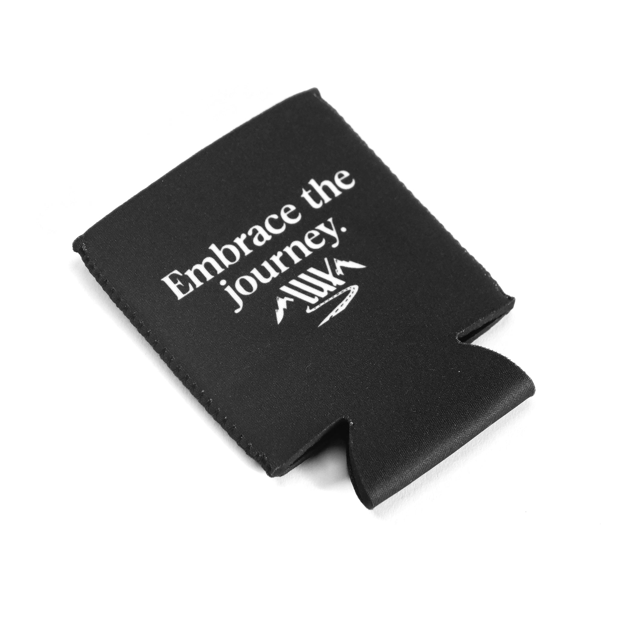 A LUXBMX Journey Stubbie Cooler made of black neoprene with "Embrace the journey." and white mountain graphics, shown on a white background.