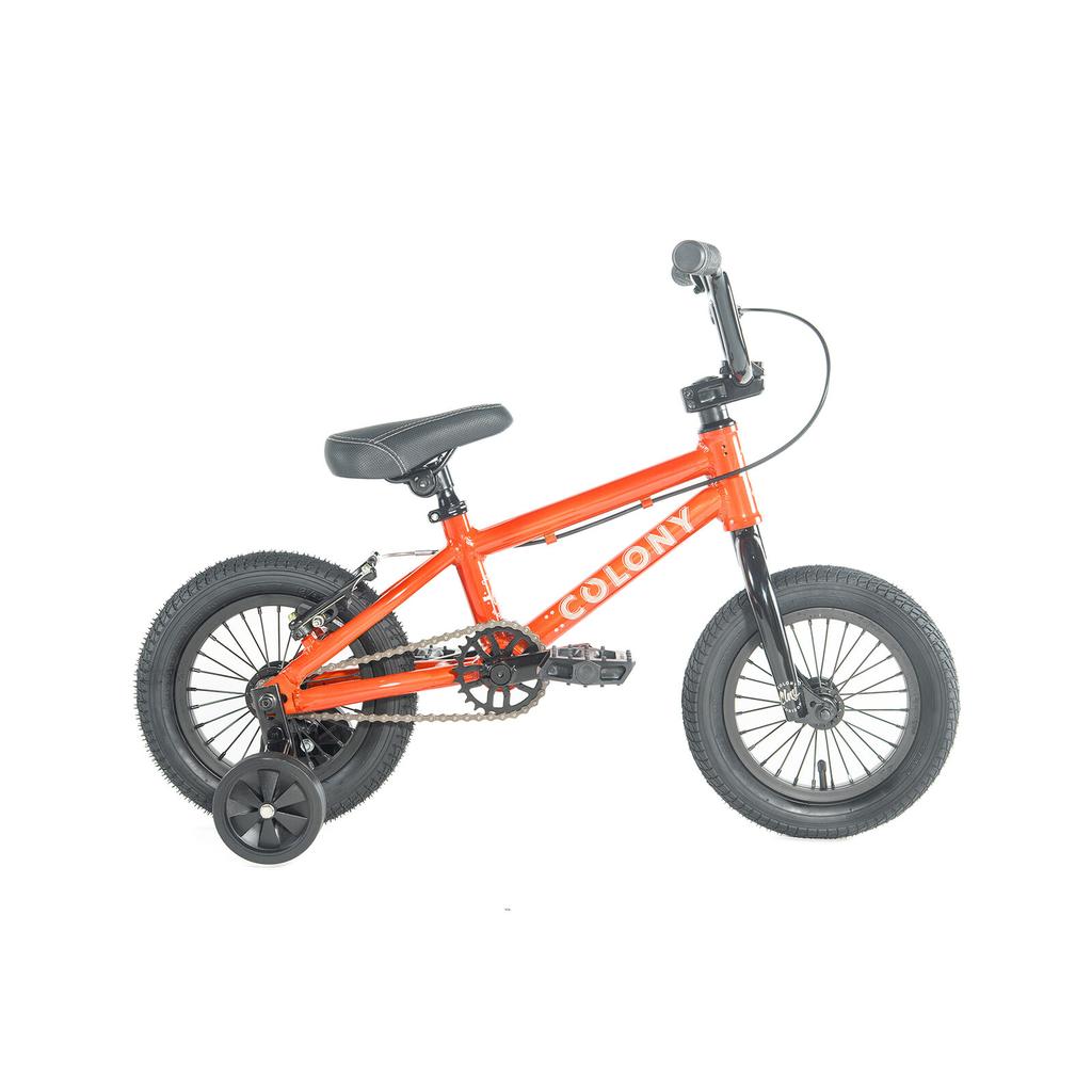 The Colony Horizon 12 Inch Bike is a small orange BMX with an alloy frame, black training wheels, pedals, and handlebars—shown in profile on a white background—making it the perfect starter bike.