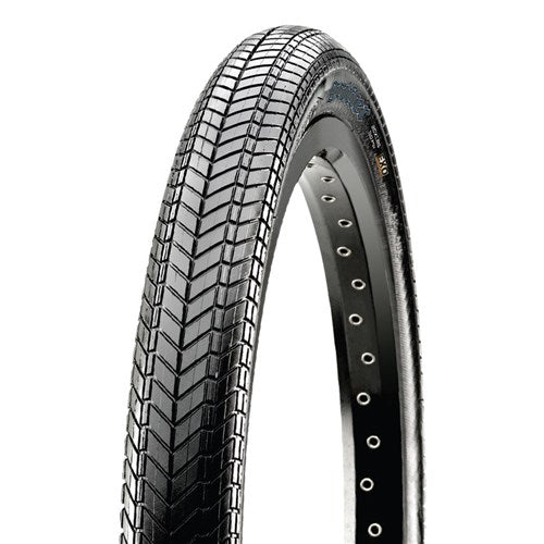 A close-up of the Maxxis Grifter Wire Bead Tyre, a lightweight BMX tire with a chevron tread pattern, partially mounted on a metal rim showing spoke holes.