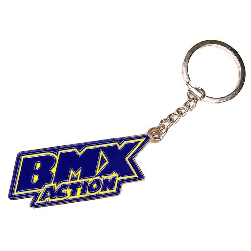 The MCS BMX Action Key Ring features a blue and yellow "BMX ACTION" logo in soft enamel on zinc alloy, attached by a short chain to a round key ring.