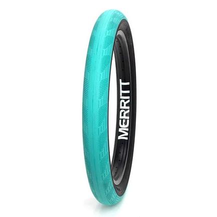 A teal-colored Merritt Phantom Tyre standing upright against a white background.