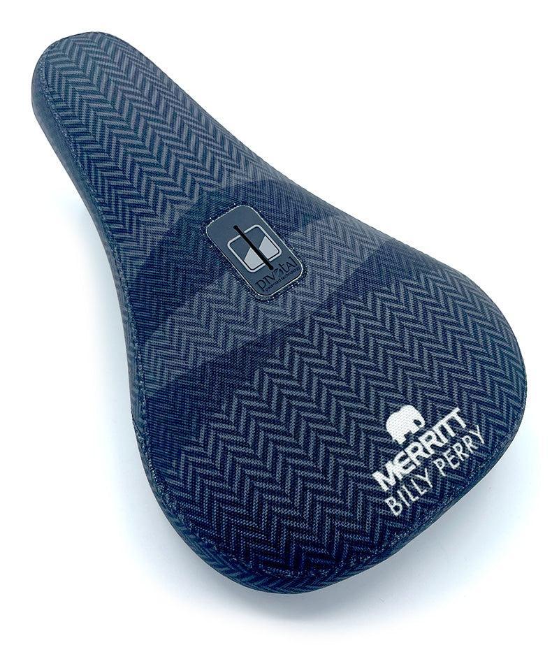 The Merritt Billy Perry Pivotal Seat features a blue herringbone canvas cover, white Merritt logo, and "Billy Perry" text for stylish durability—perfect for any BMX rider seeking the Billy Perry Signature look.
