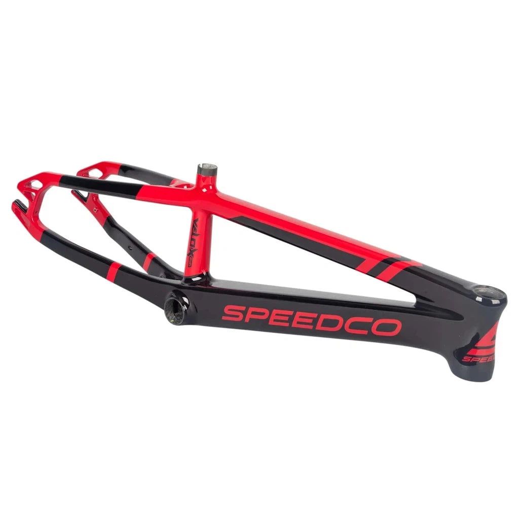 Speedco Velox EVO Carbon Frame PRO L featuring aerodynamic tubing and a sleek red and black design. This high-performance racing frame is equipped with a durable downtube/BB interface for superior power transfer.