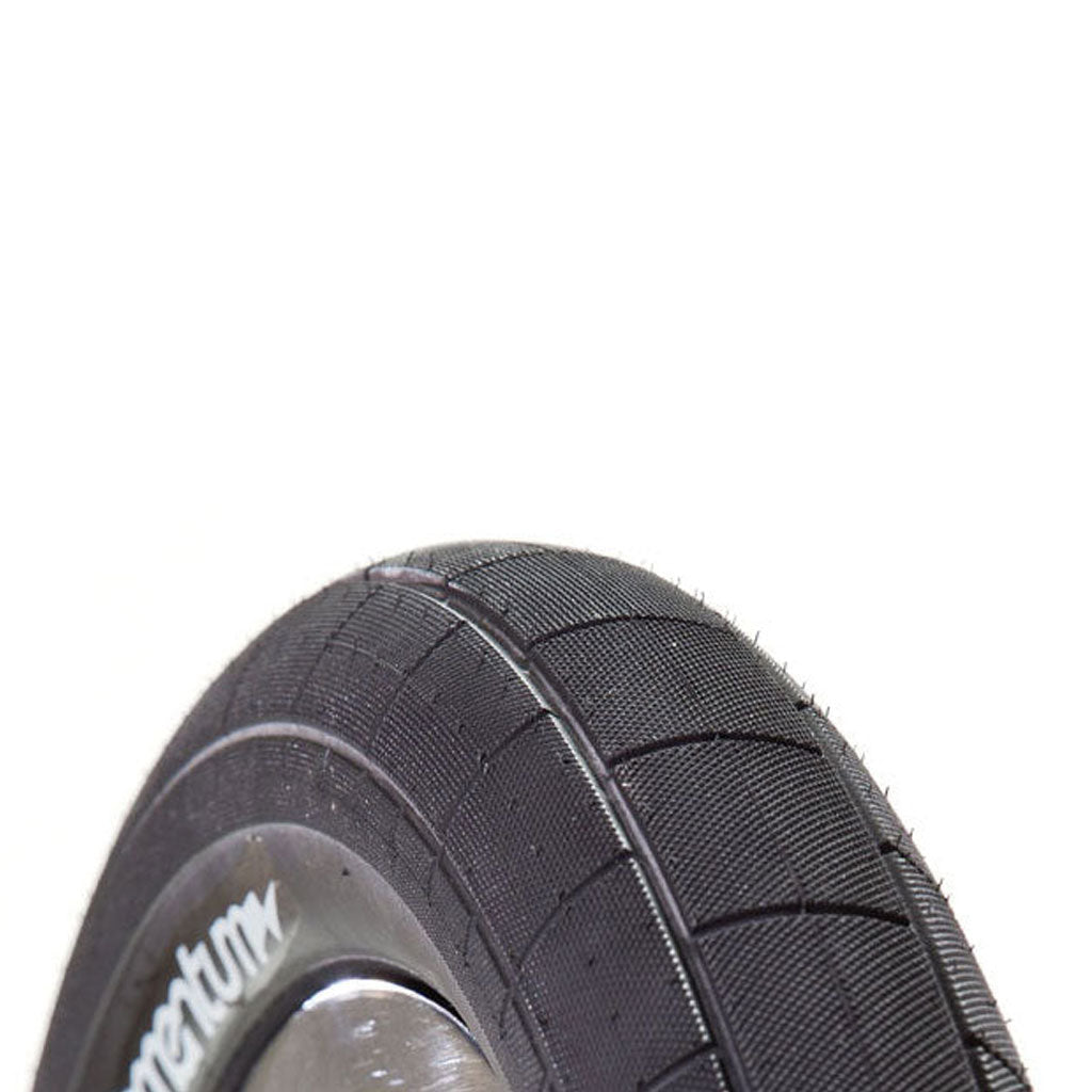 A close up of a wire bead tire, specifically the Demolition Momentum tyre commonly used for BMX.