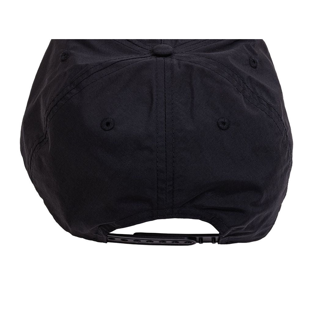 A black Odyssey Service Patch Cap viewed from the back, showcasing the adjustable strap with snap buttons—truly an Odyssey hat.