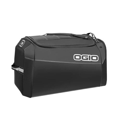 The Ogio Gear Bag / Prospect Stealth is a black duffel made from eco-friendly PVC and durable fabric, featuring a zippered main compartment, handle, and shoulder strap for versatile use while minimizing environmental impact.
