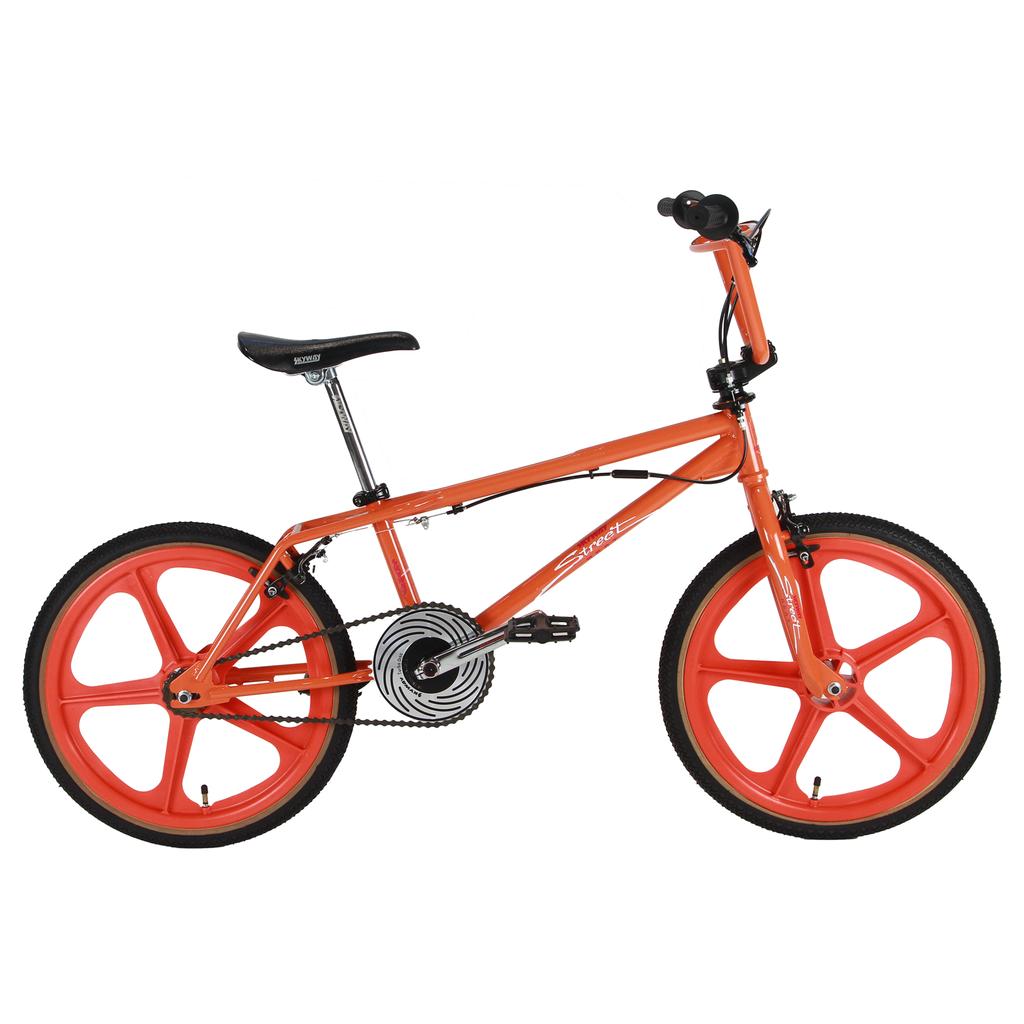The Skyway Street Beat 20 Inch Bike features a bright orange frame with mag wheels, black saddle, and handlebars, displayed in a side profile on a white background.