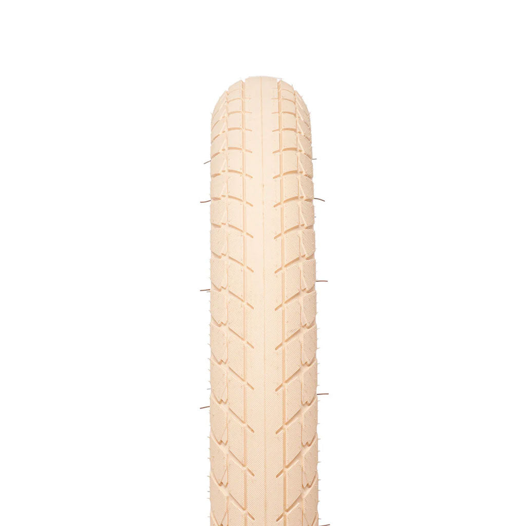 A beige Eclat Optima Tyre is displayed top-down on a white background, clearly showing its all-terrain tread and texture.