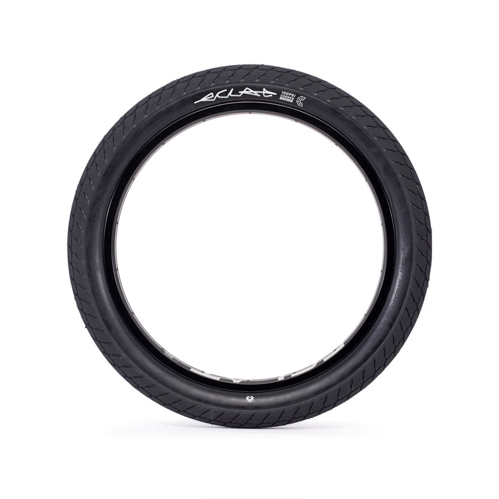 A black Eclat Optima Tyre featuring all-terrain tread and puncture protection is mounted on a silver rim, shown against a white background.