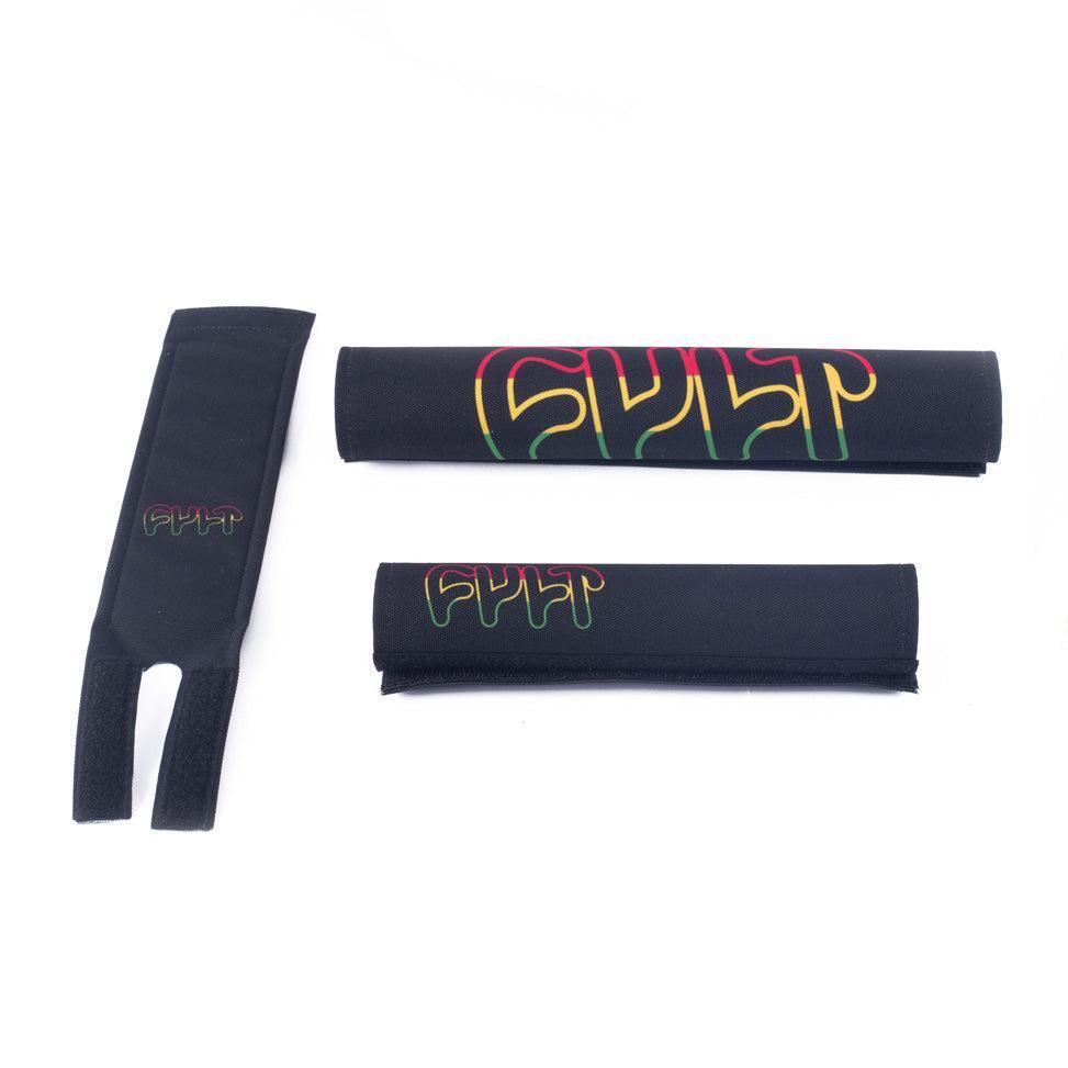 The Cult Pad Set (Rasta Edition), featuring three black pads with the "CULT" logo in red, yellow, and green, is displayed on a white background.